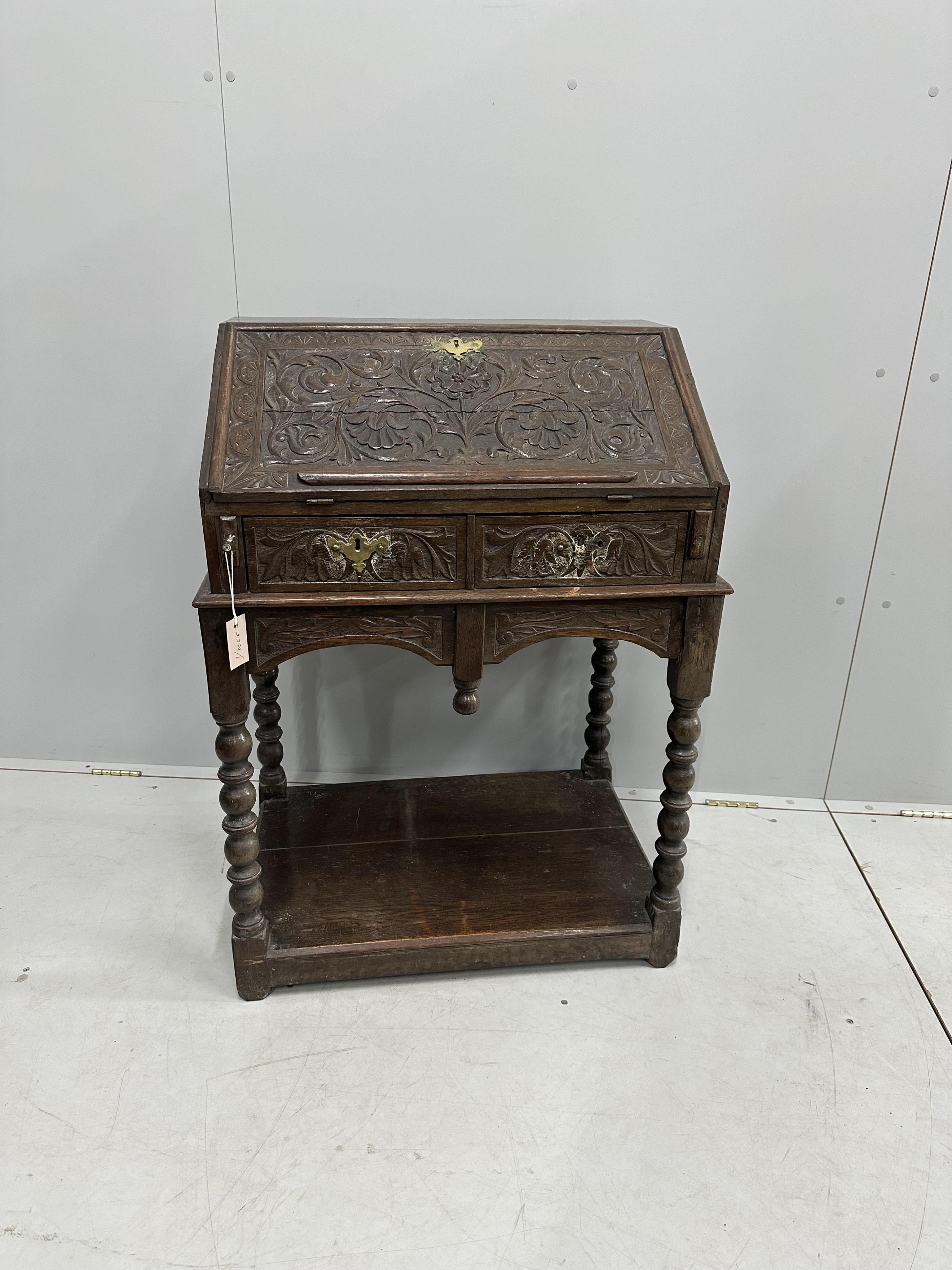 A carved oak bureau, width 68cm, depth 48cm, height 97cm